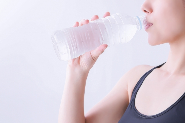 ウォーターサーバーの水を飲む女性